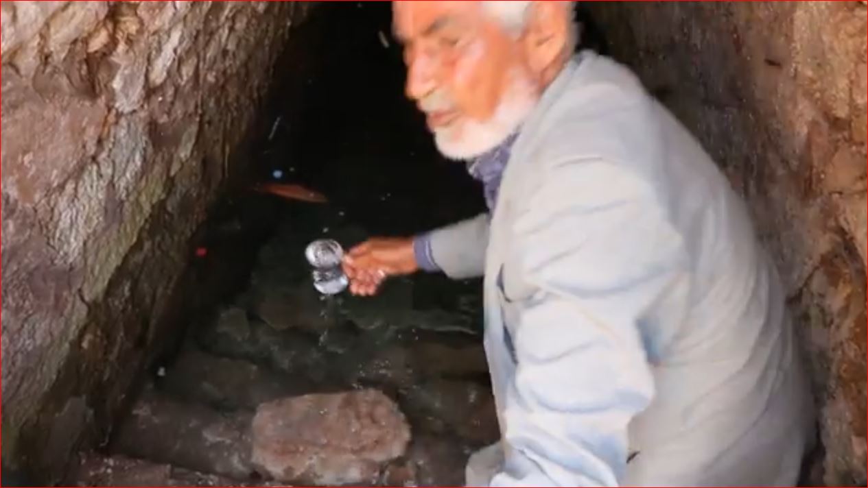 The mayor draws water from the well into a cup