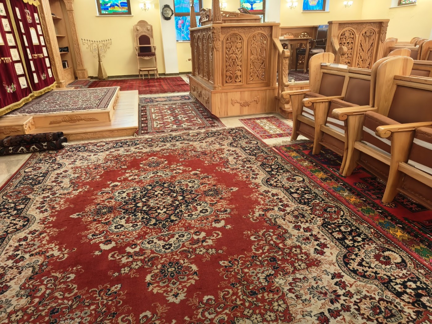 שטיחים אזריים ופרסיים יקרים עוטפים את רצפת בית הכנסת של יהודי ההרים